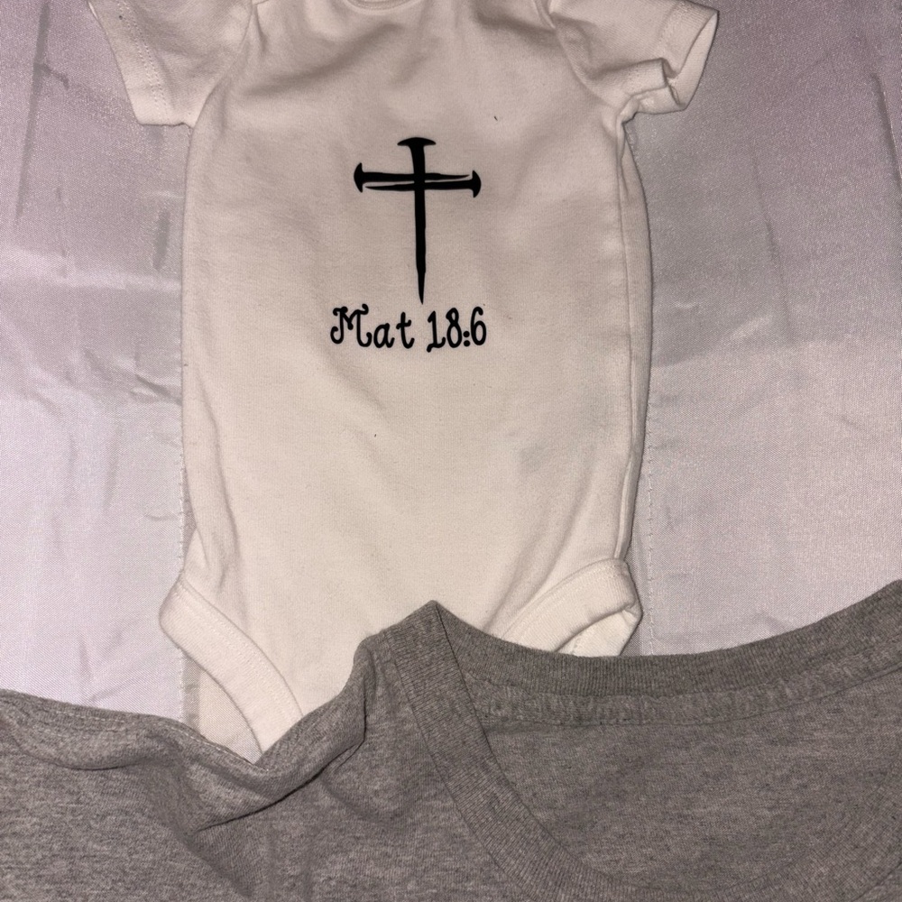 White Baby Onesie with Black Cross Design